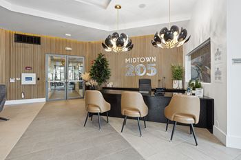 the lobby of the midtown apartments has a reception desk and chairs